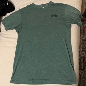 Green North face shirt.